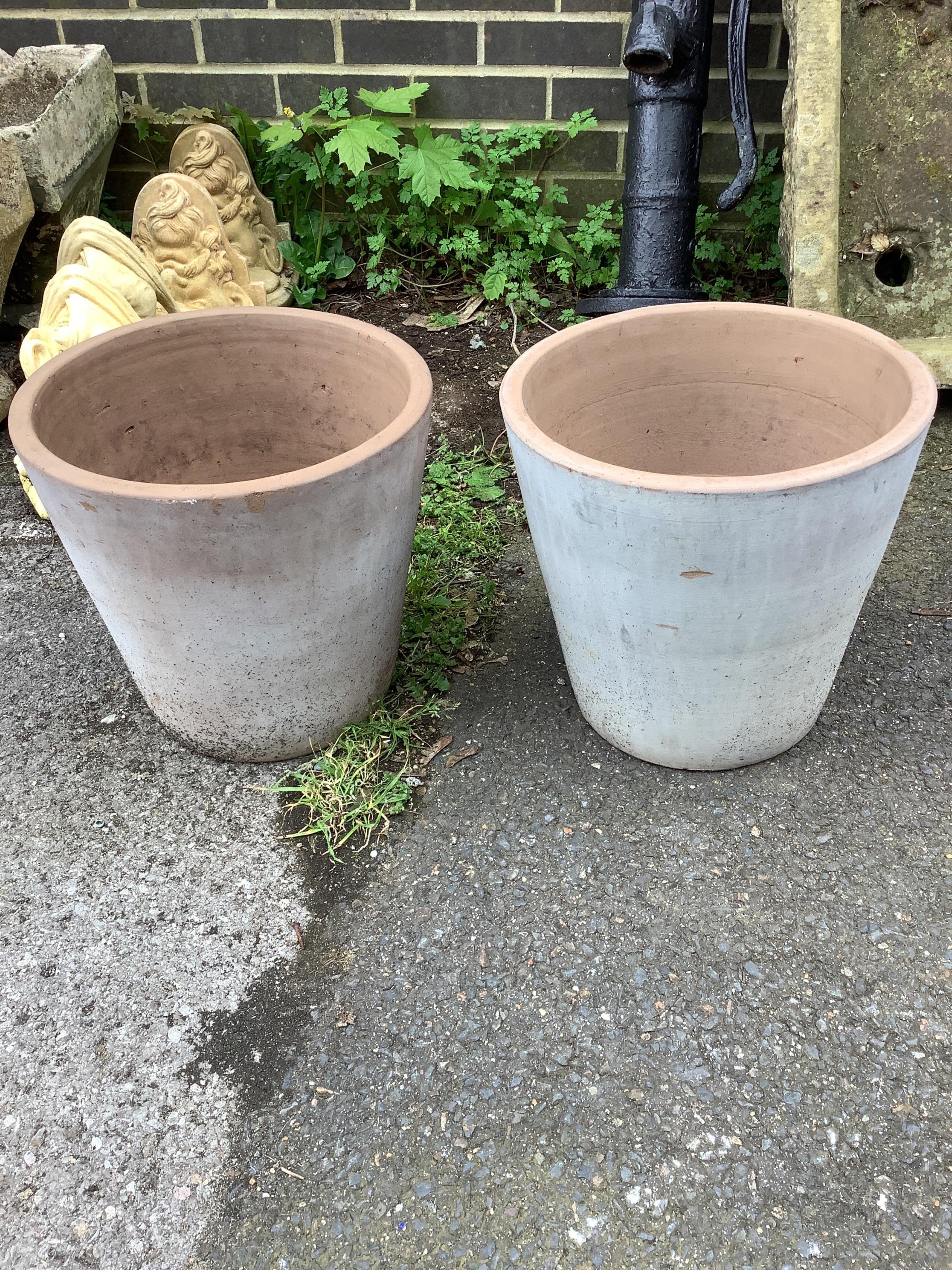 A pair of circular terracotta garden planters, diameter 35cm, height 33cm